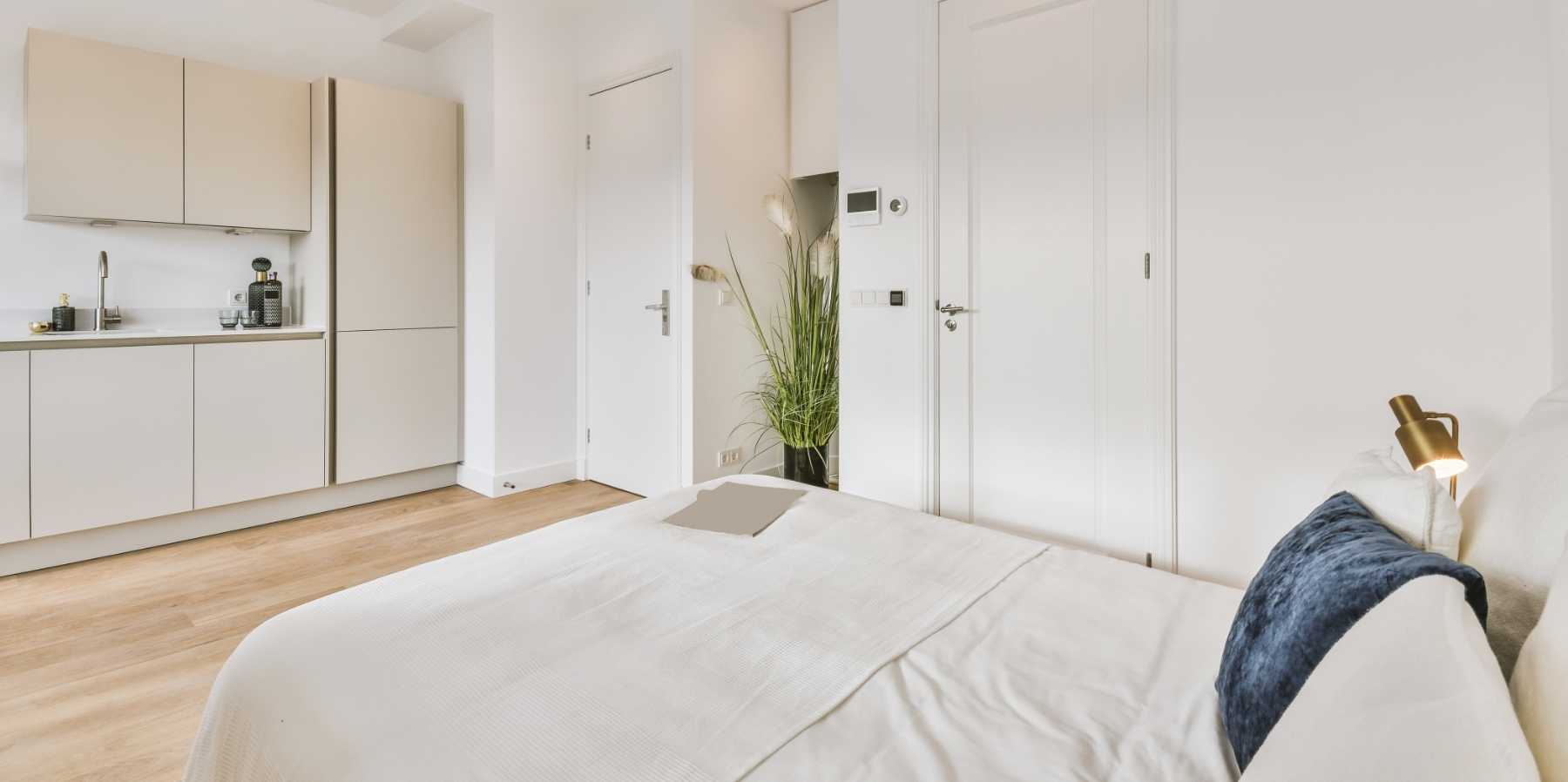 Esempio di monolocale con cucina a vista su zona letto